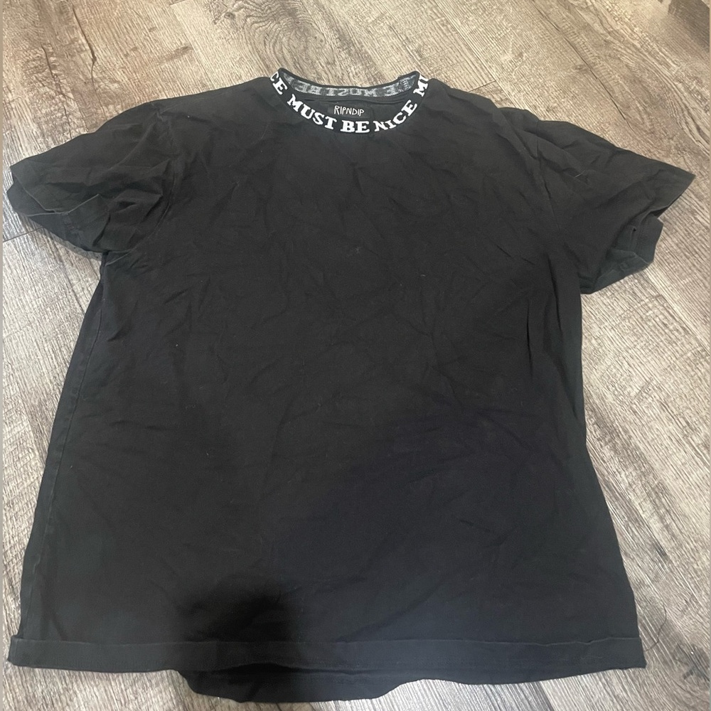 Black ripndip shirt with “must be nice” on collar